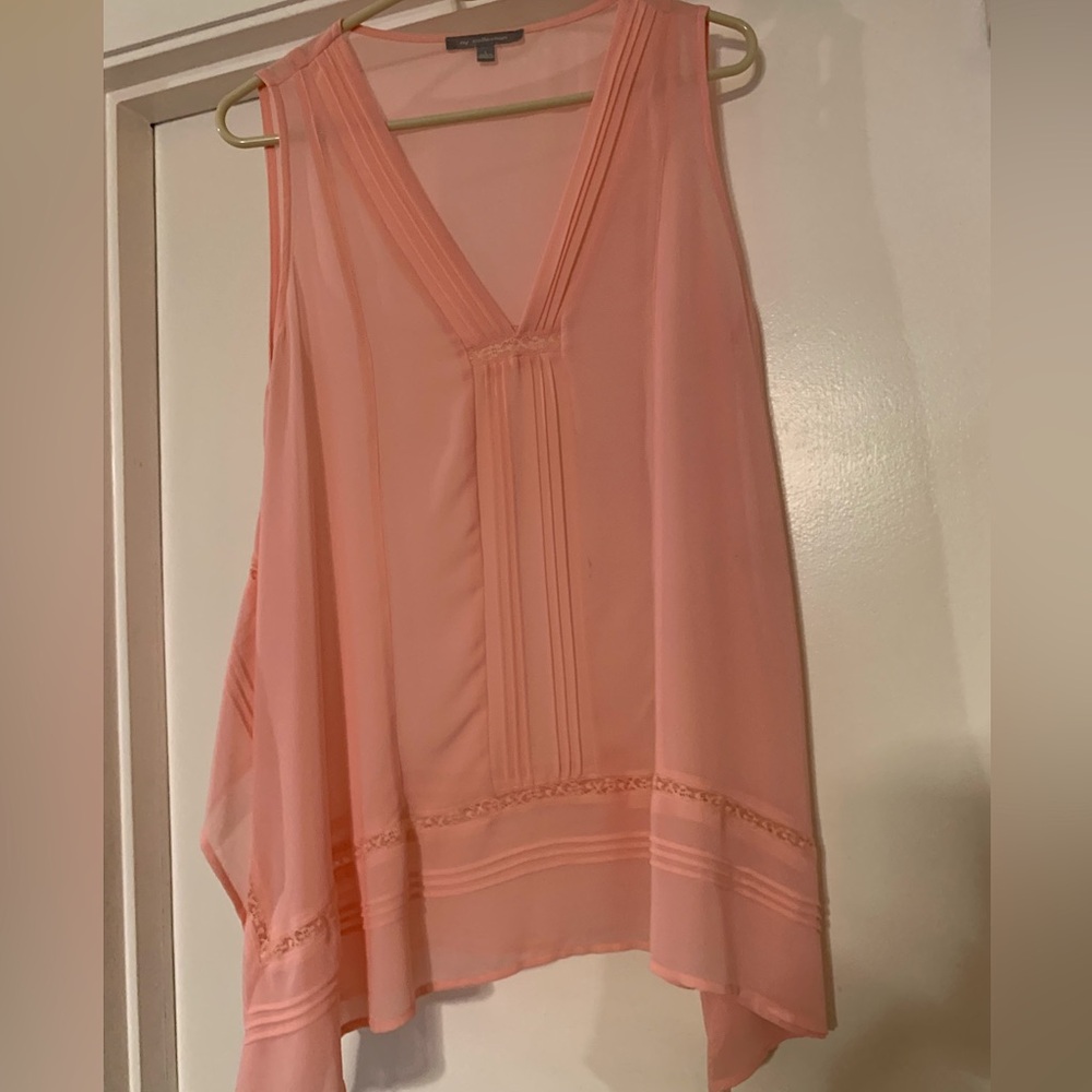 Sheer sleeveless top with side splits.
